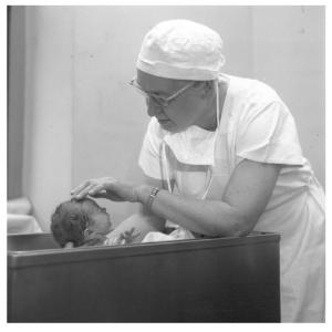 Dr. Apgar with an infant, 1958